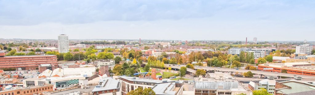 A cityscapewqith commercial, residential buildings with some trees.