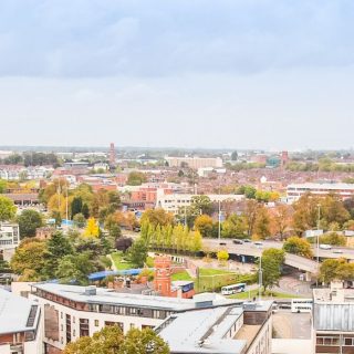 A cityscapewqith commercial, residential buildings with some trees.